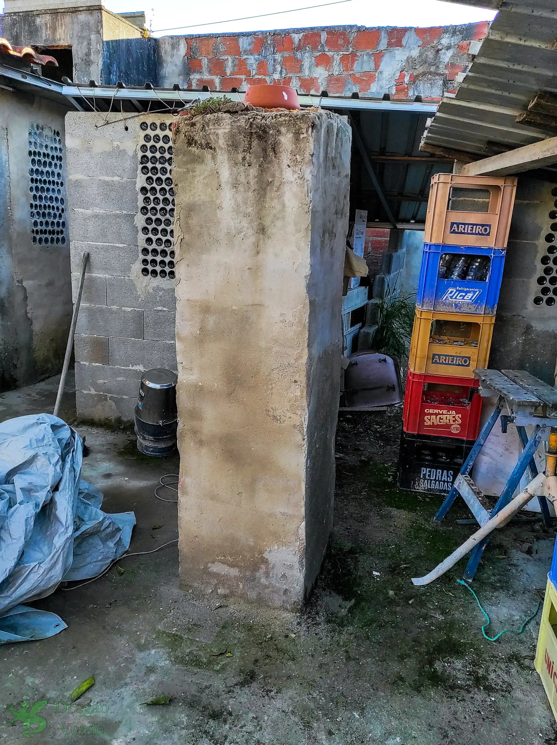 Masonry pillar in yard used to support a bird-bath